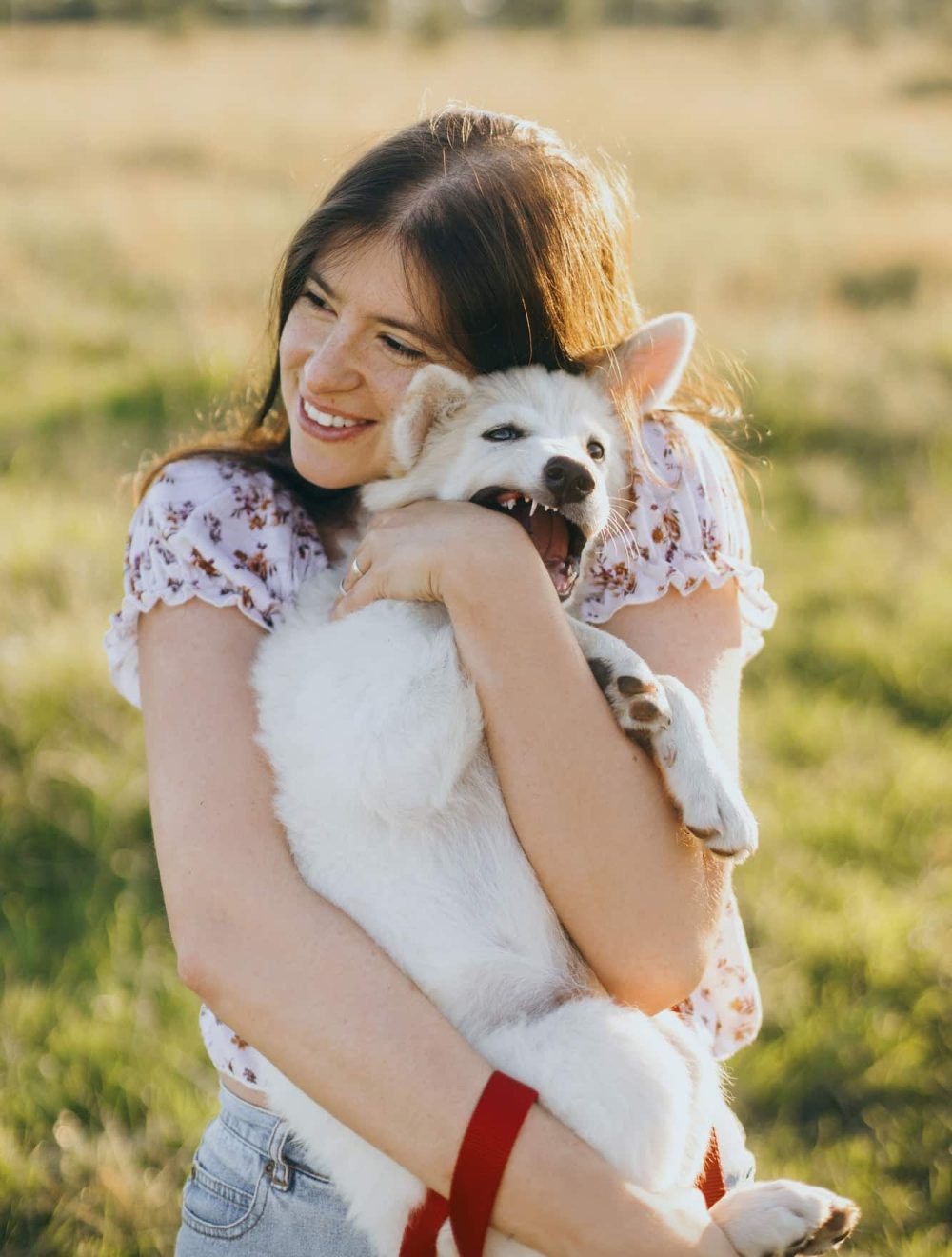young-woman-hugging-cute-white-puppy
